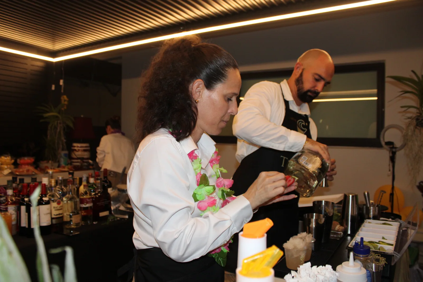 Tipsy Tides bartenders mixing drinks at a night event