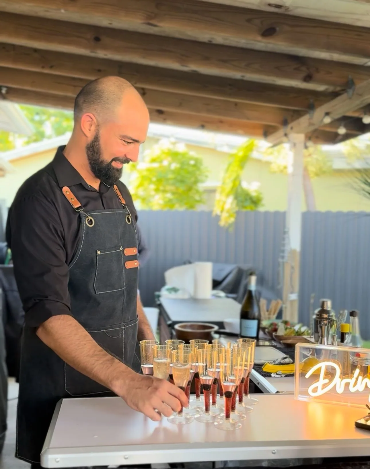 Tipsy Tides bartender preparing a drink outdoors
