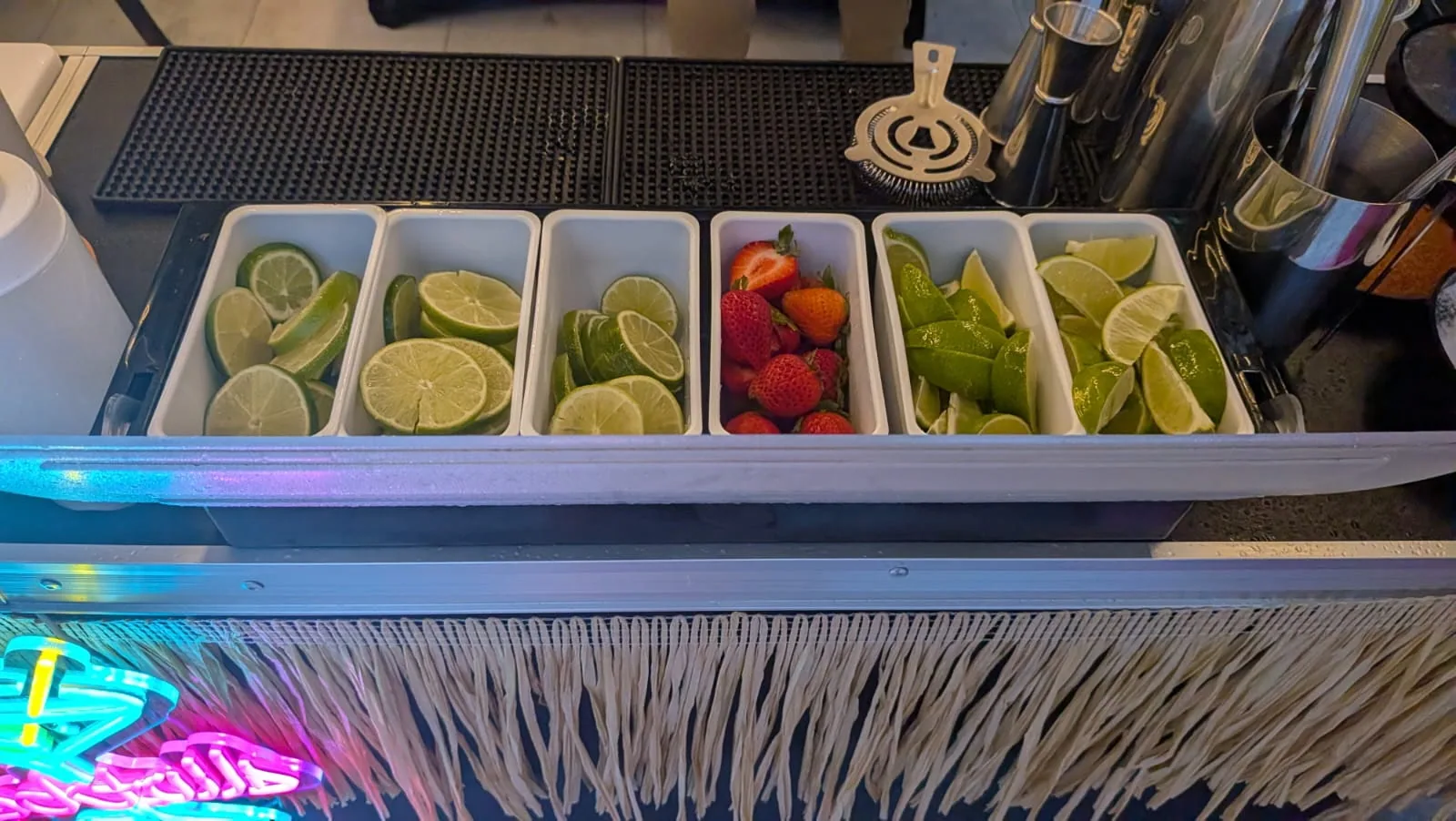Fresh lime and fruit garnish trays ready for service