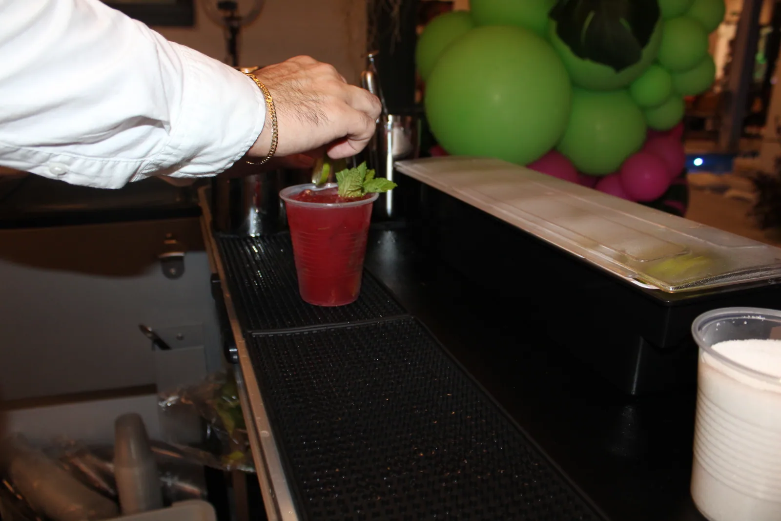 Close-up of a pink cocktail being prepared